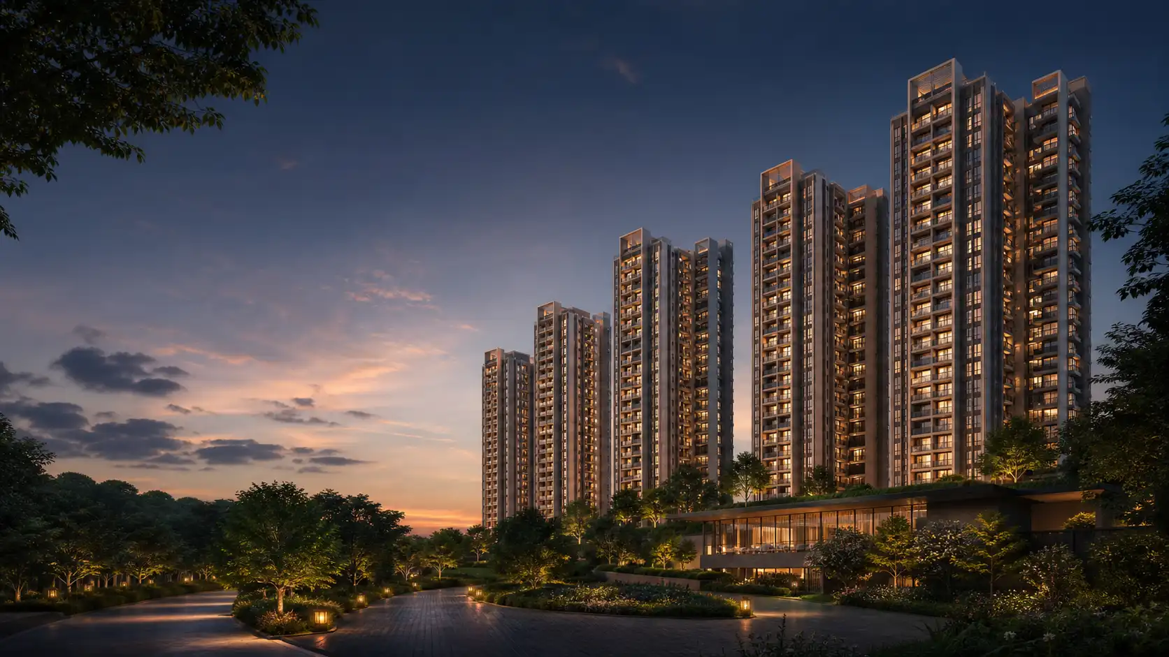 high-rise residential community with a landscaped foreground at dusk
